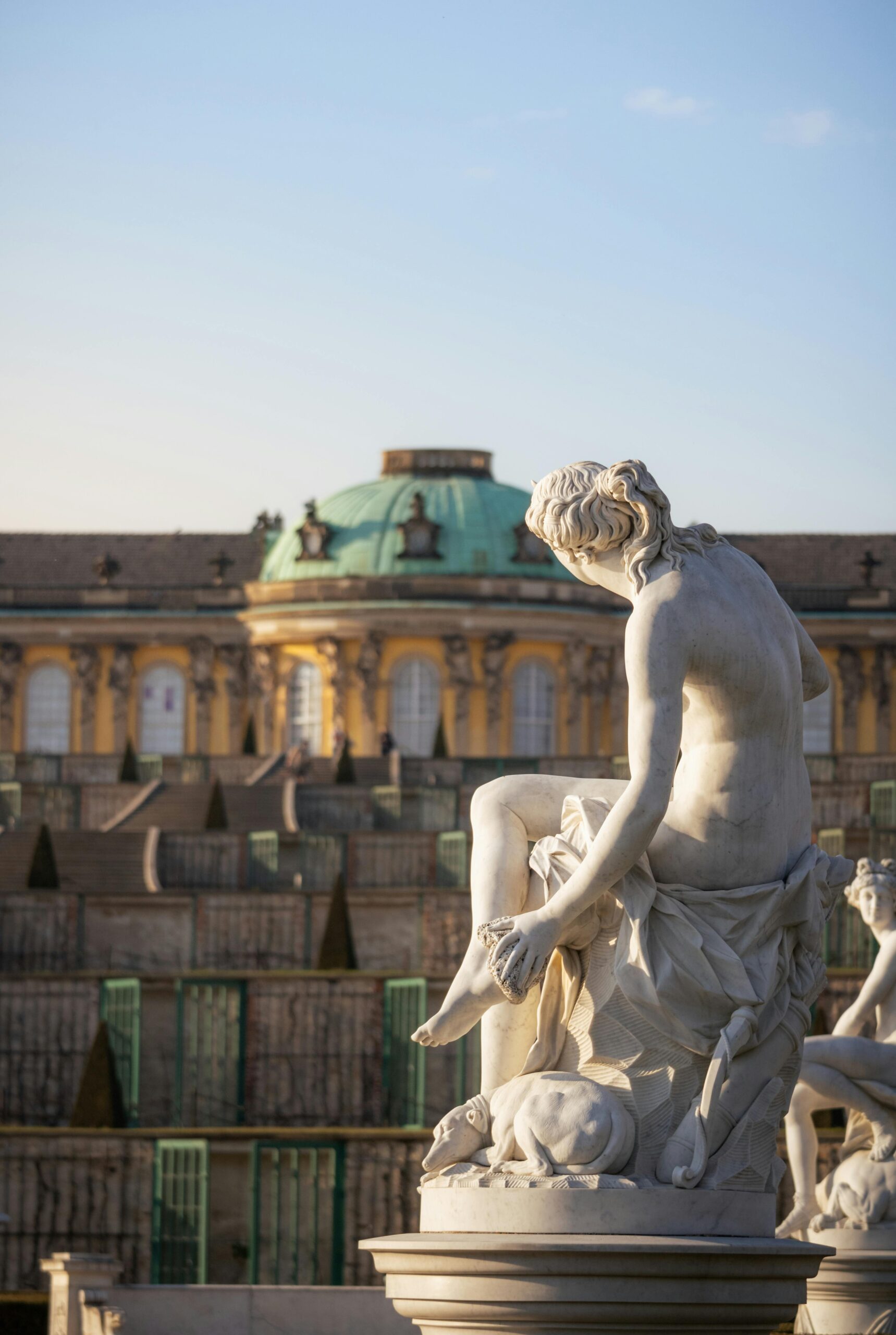 Explore the grandeur of Sanssouci Palace with this striking marble sculpture in Potsdam, Germany.