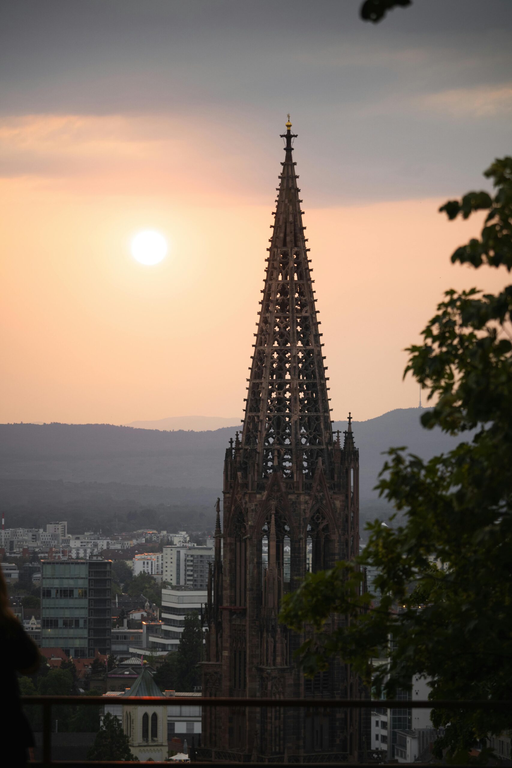 Captivating sunset view of Freiburg Cathedral in Freiburg im Breisgau, Germany, with a scenic cityscape.
